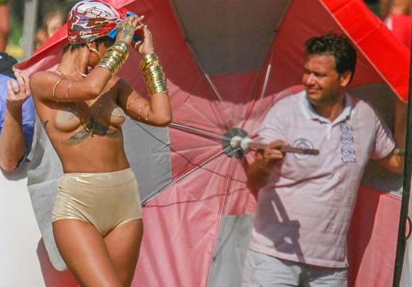 Rihanna poses topless for Vogue 